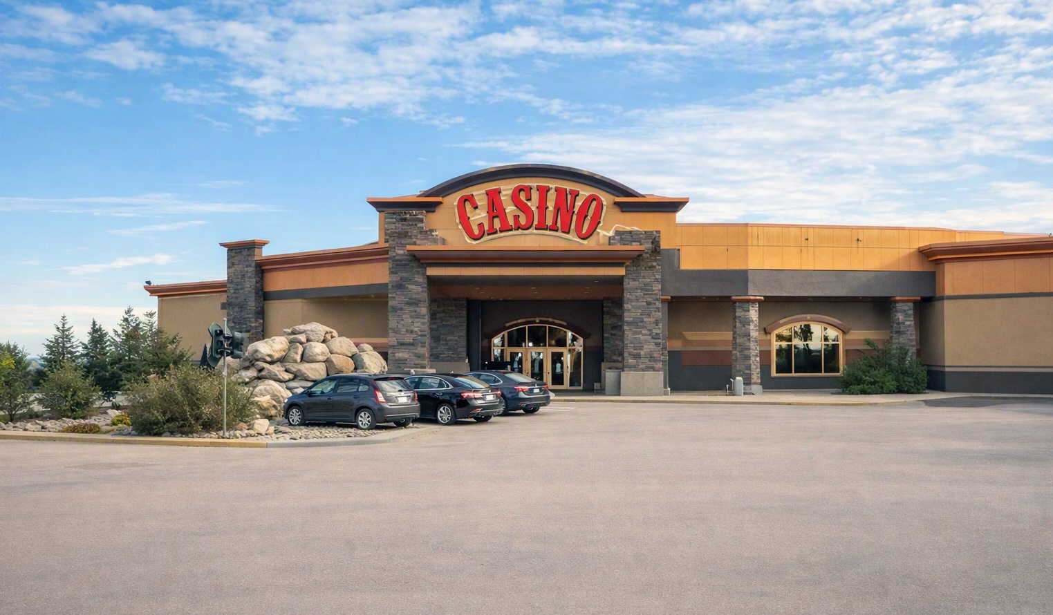 Exterior view of Pure Casino in Alberta with large red “CASINO” sign above the entrance, photographed during daytime with clear sky and parking area visible.